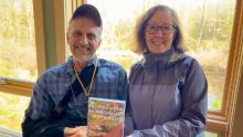 Dave Warners and Gail Heffner holding their new book, 